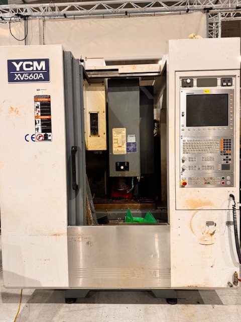 YCM XV560A CNC vertical machining centre showing front control panel and machine enclosure