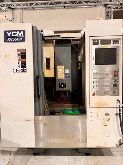 YCM XV560A CNC vertical machining centre showing front control panel and machine enclosure